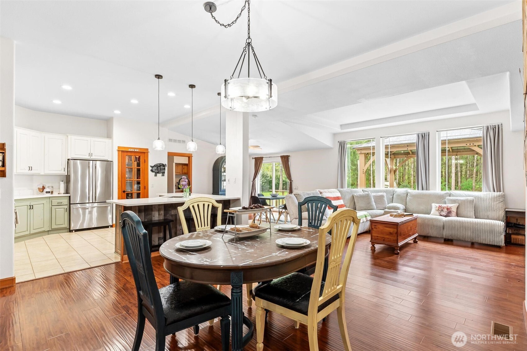 4915 Schwarzmiller Road Lake Stevens, WA 98258 - Photo 12 of 40 a view of a dining room with furniture window and wooden floor