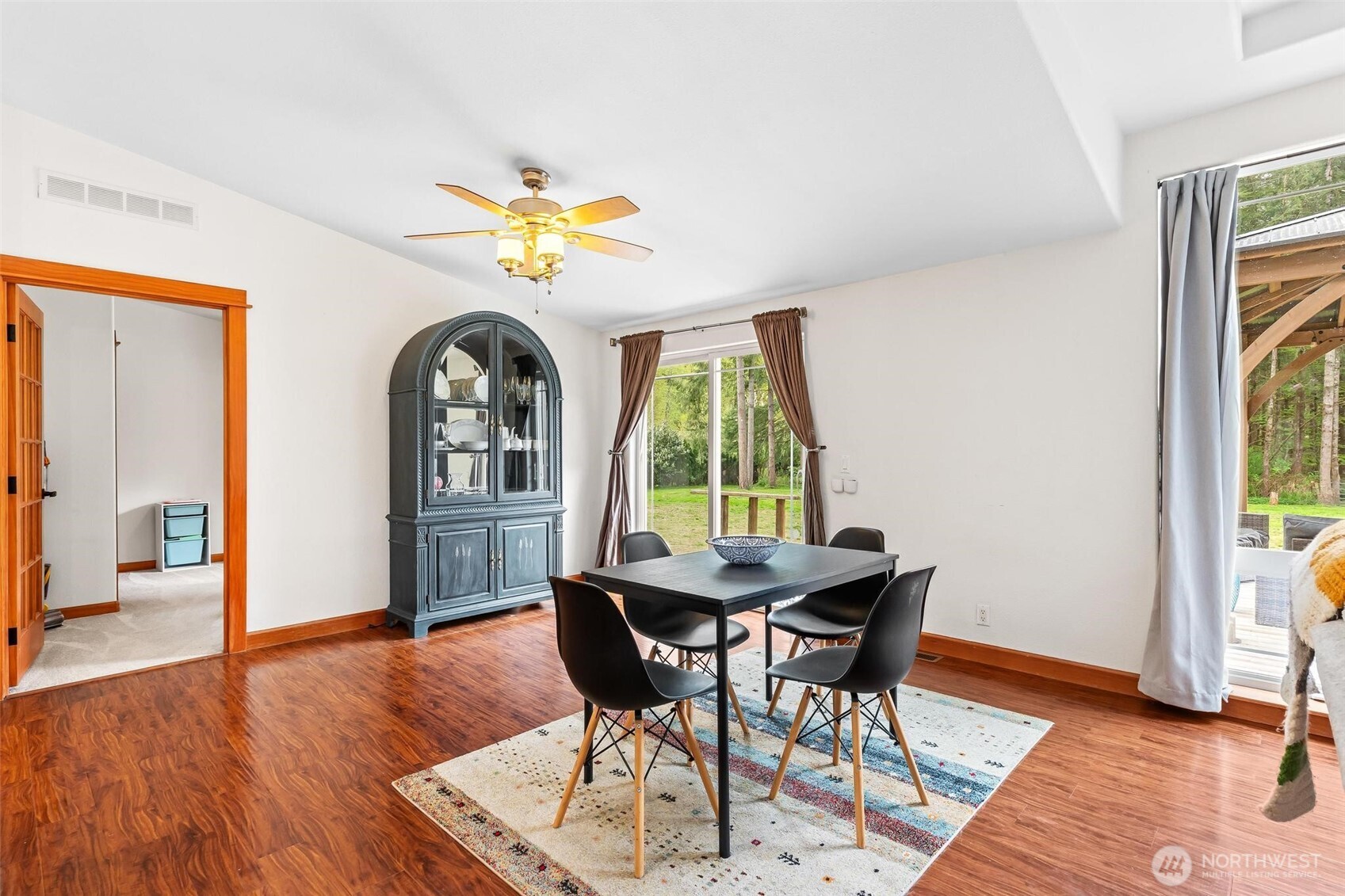 4915 Schwarzmiller Road Lake Stevens, WA 98258 - Photo 16 of 40 a view of a dining room with furniture window and wooden floor
