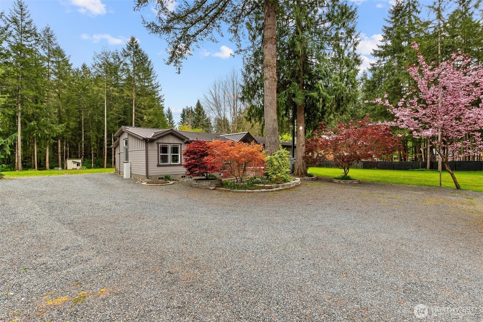 4915 Schwarzmiller Road Lake Stevens, WA 98258 - Photo 3 of 40 a front view of a house with a yard and trees