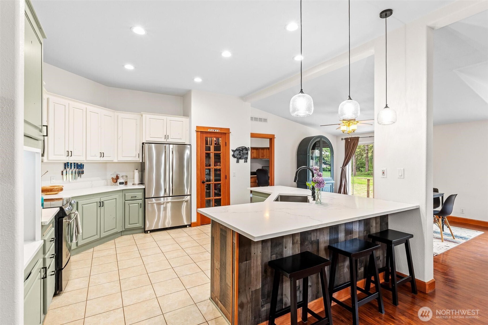 4915 Schwarzmiller Road Lake Stevens, WA 98258 - Photo 8 of 40 a kitchen with stainless steel appliances kitchen island granite countertop a table chairs and a refrigerator