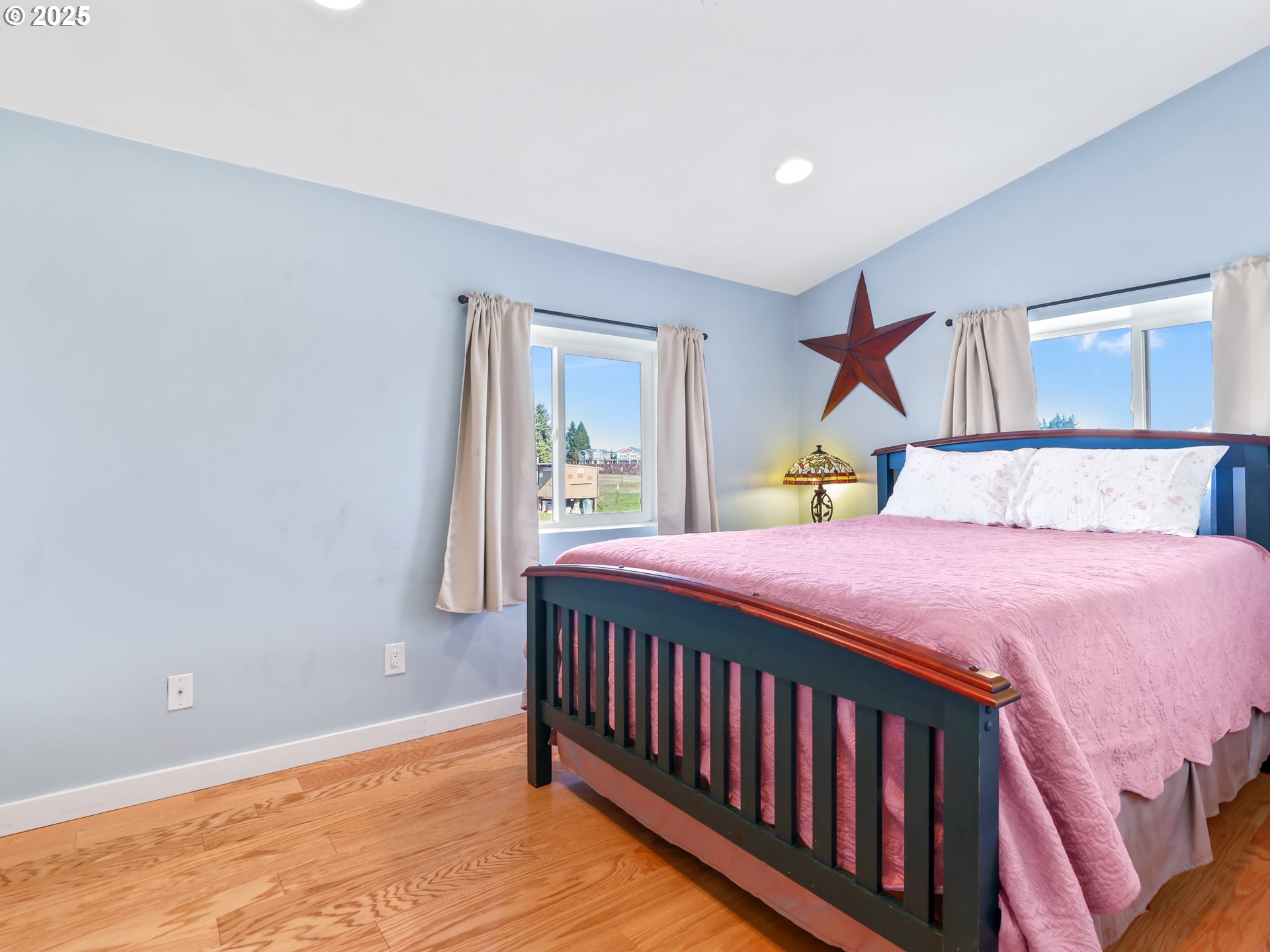 5714 Northwest 169th Street Ridgefield, WA 98642 - Photo 20 of 48 a bedroom with a bed and wooden floor