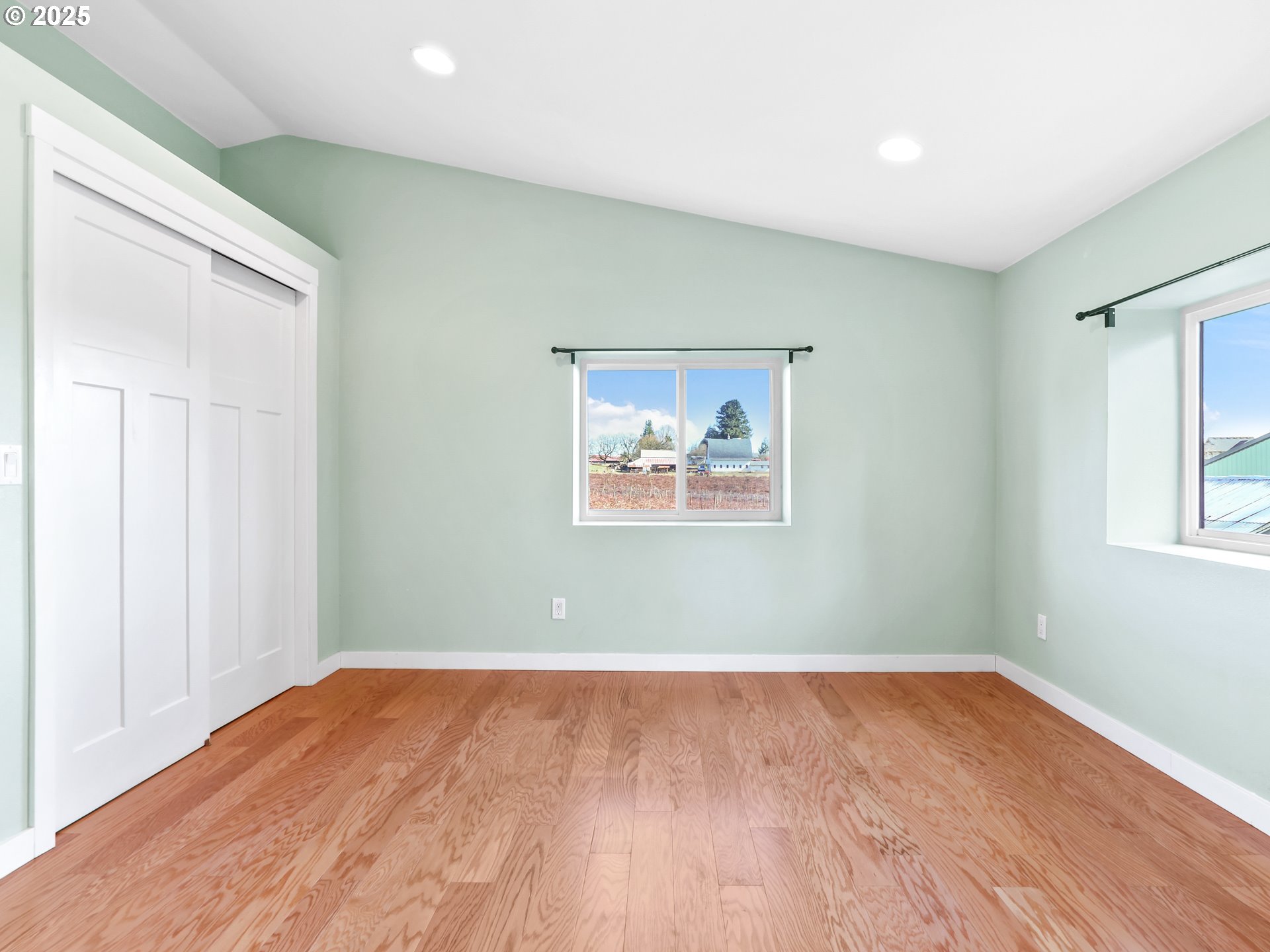 5714 Northwest 169th Street Ridgefield, WA 98642 - Photo 21 of 48 a view of a room with wooden floor and window
