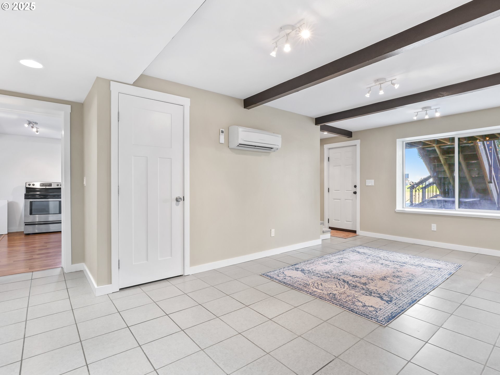 5714 Northwest 169th Street Ridgefield, WA 98642 - Photo 24 of 48 an empty room with kitchen view and wooden floor