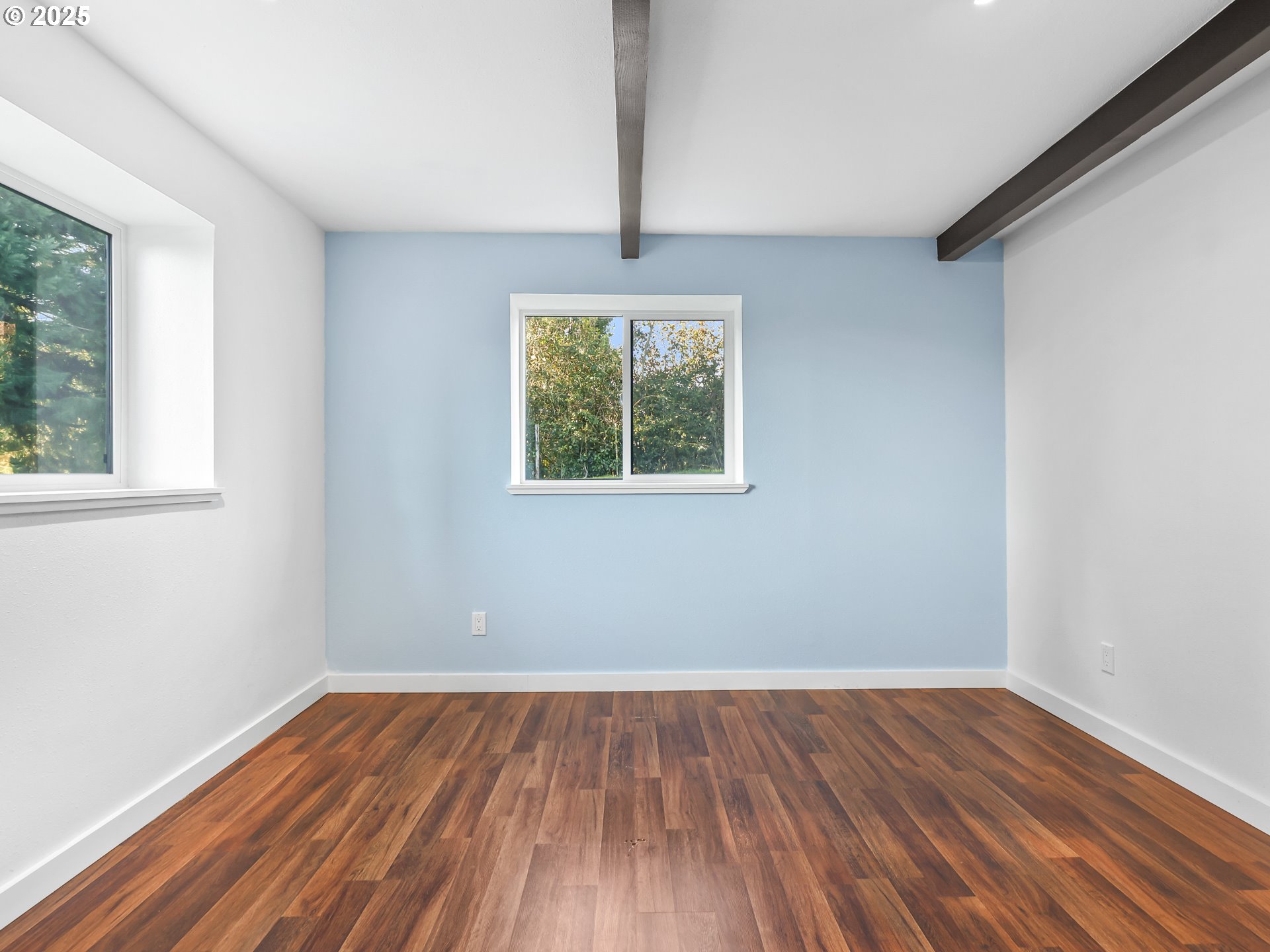 5714 Northwest 169th Street Ridgefield, WA 98642 - Photo 25 of 48 a view of an empty room with wooden floor and a window