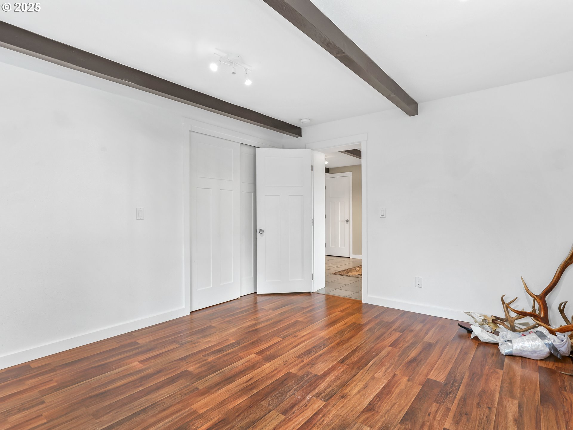 5714 Northwest 169th Street Ridgefield, WA 98642 - Photo 27 of 48 a view of empty room with wooden floor and fan