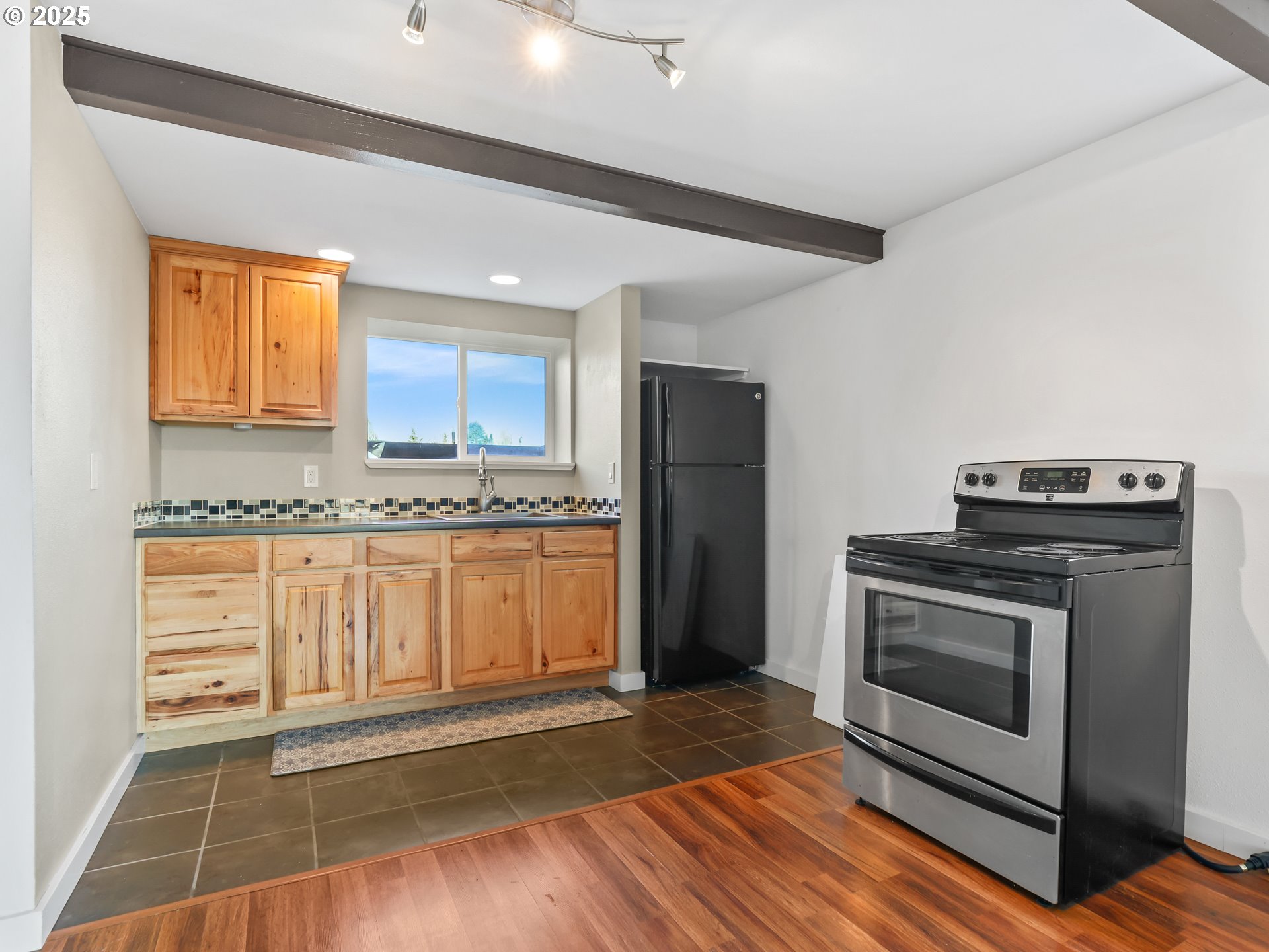 5714 Northwest 169th Street Ridgefield, WA 98642 - Photo 30 of 48 a kitchen with granite countertop a refrigerator and a stove top oven