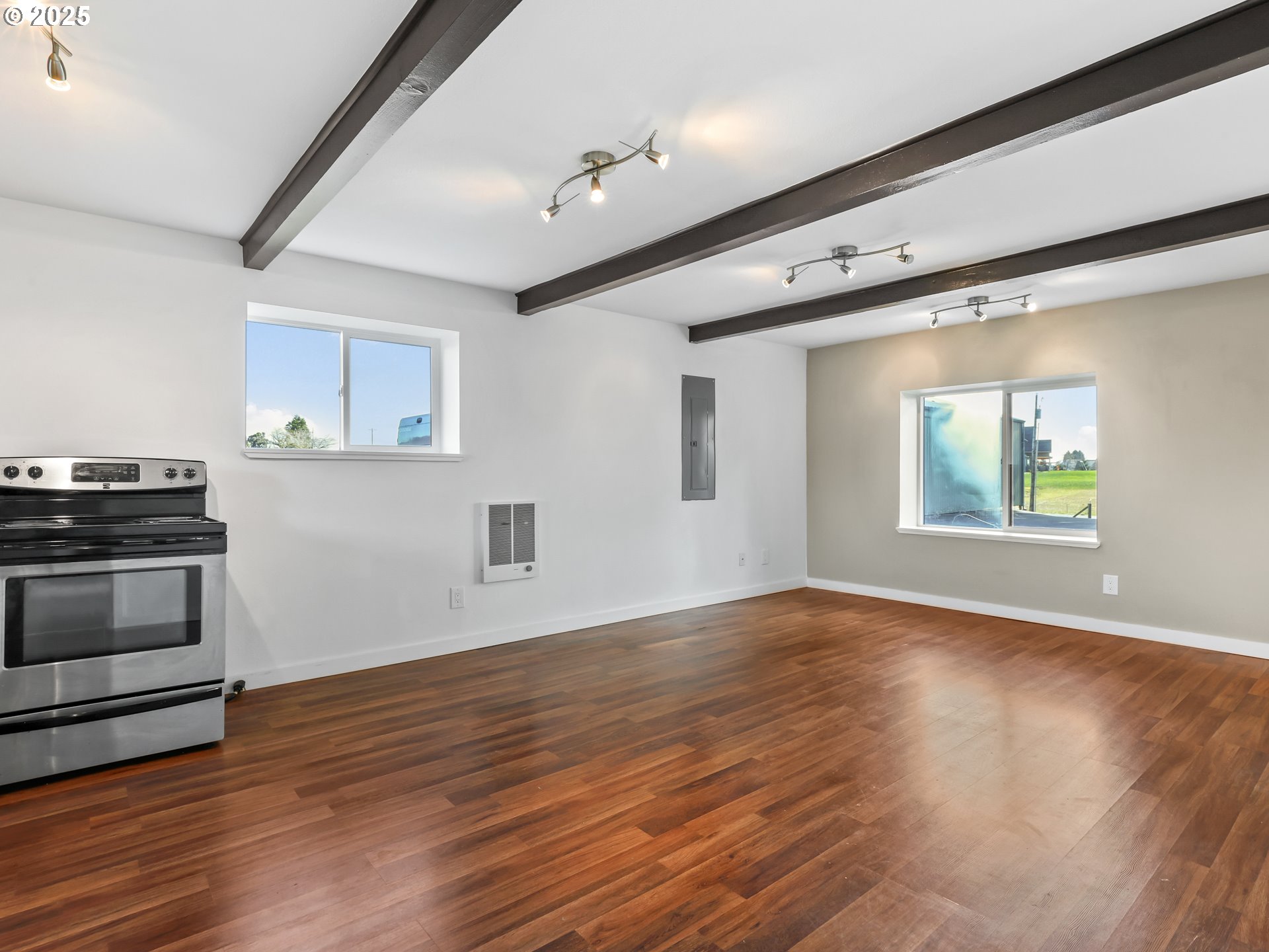 5714 Northwest 169th Street Ridgefield, WA 98642 - Photo 31 of 48 a view of an empty room with wooden floor and a window