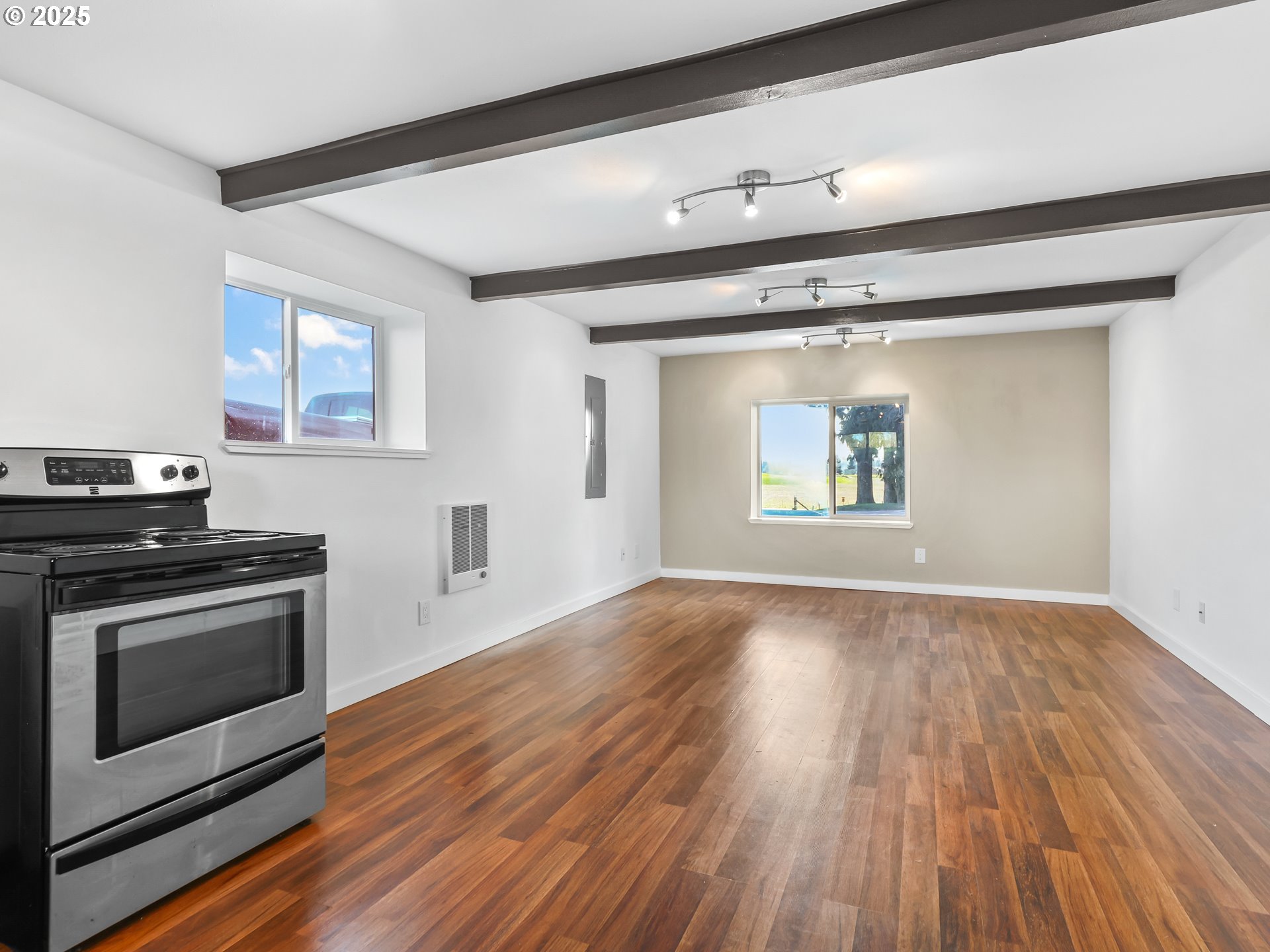 5714 Northwest 169th Street Ridgefield, WA 98642 - Photo 32 of 48 a view of an empty room with wooden floor and a window