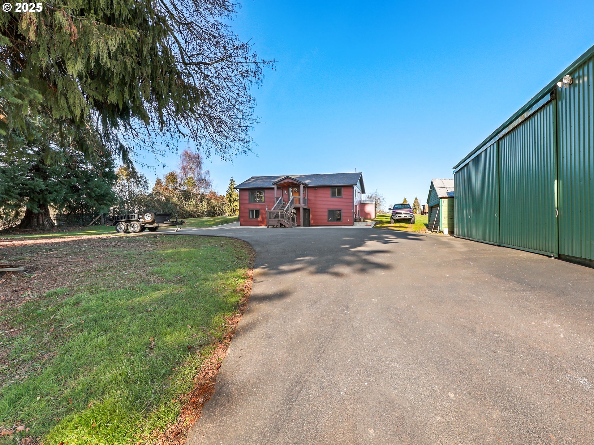 5714 Northwest 169th Street Ridgefield, WA 98642 - Photo 43 of 48 a view of a street with a building and trees in the background