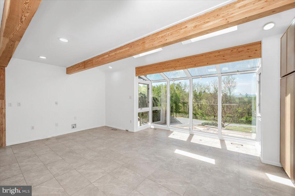 11127 Dublin Road Woodsboro, MD 21798 - Photo 13 of 62 a view of an empty room with wooden floor and a window
