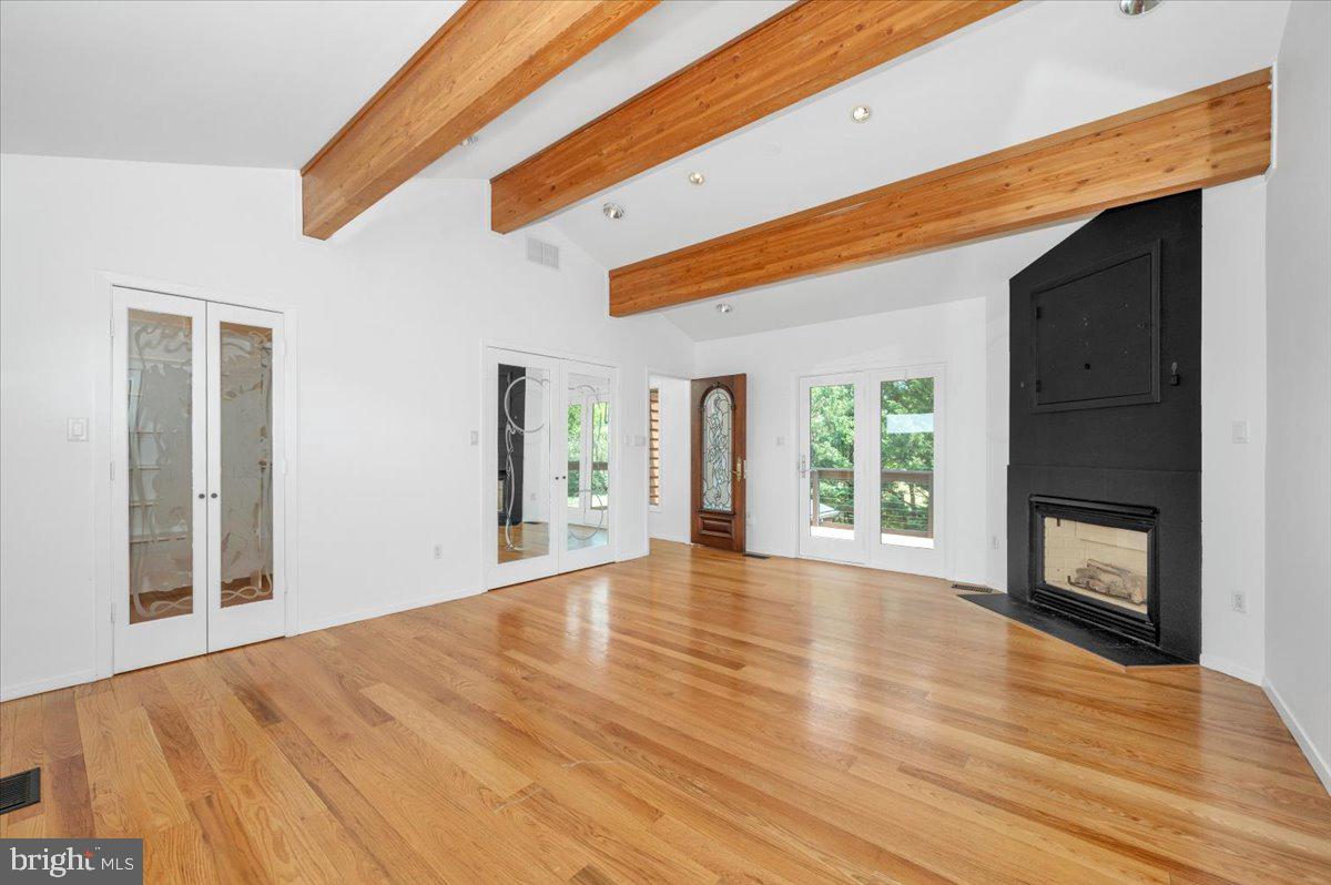 11127 Dublin Road Woodsboro, MD 21798 - Photo 42 of 62 a view of an empty room with wooden floor fireplace and a window