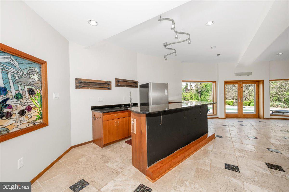 11127 Dublin Road Woodsboro, MD 21798 - Photo 51 of 62 a kitchen with stainless steel appliances granite countertop a refrigerator a sink dishwasher a stove and a dining table with wooden floor