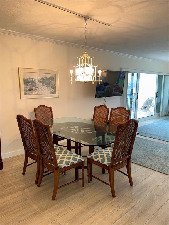 3240 Gulf Of Mexico Drive, Unit B402 Longboat Key, FL 34228 - Photo 3 of 15 a dining room with furniture and window