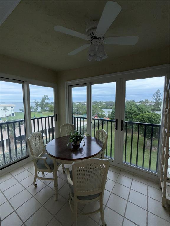 3240 Gulf Of Mexico Drive, Unit B402 Longboat Key, FL 34228 - Photo 6 of 15 a dining room with furniture window and outside view