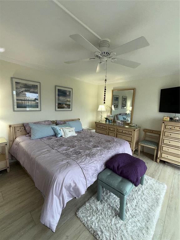3240 Gulf Of Mexico Drive, Unit B402 Longboat Key, FL 34228 - Photo 7 of 15 a bedroom with a bed a couch and a table in it