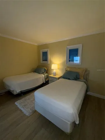 a bedroom with two beds and a couch