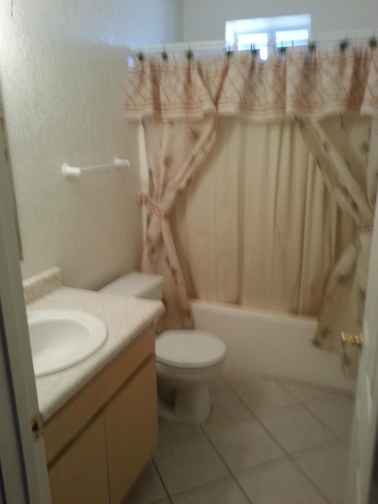 1143 Pedro Court Rio Rico, AZ 85648 - Photo 11 of 14 a bathroom with a sink a toilet and a shower