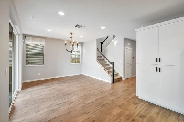 wooden floor in an empty room with a window and wooden floor
