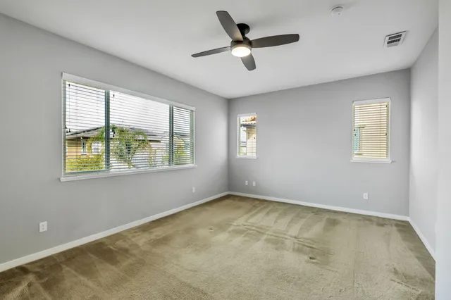 a view of room with window and ceiling fan