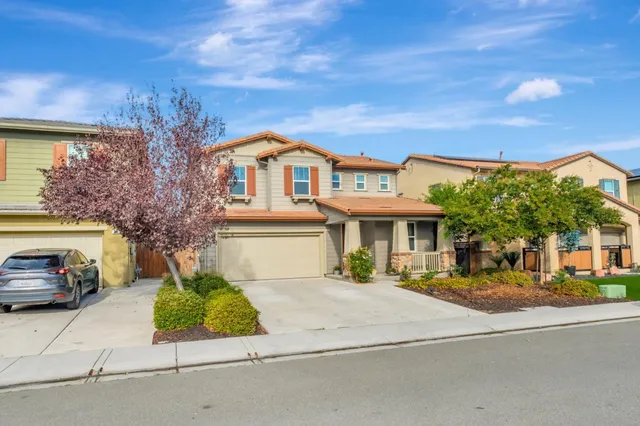 a front view of a house with garden and porch