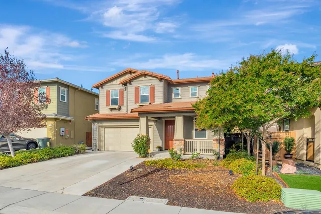 a front view of a house with garden