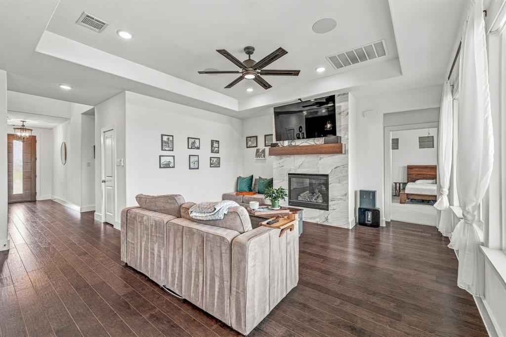 7112 Branch Road Fort Worth, TX 76179 - Photo 12 of 39 Living room with mounted TV above fireplace with surround sound built in.