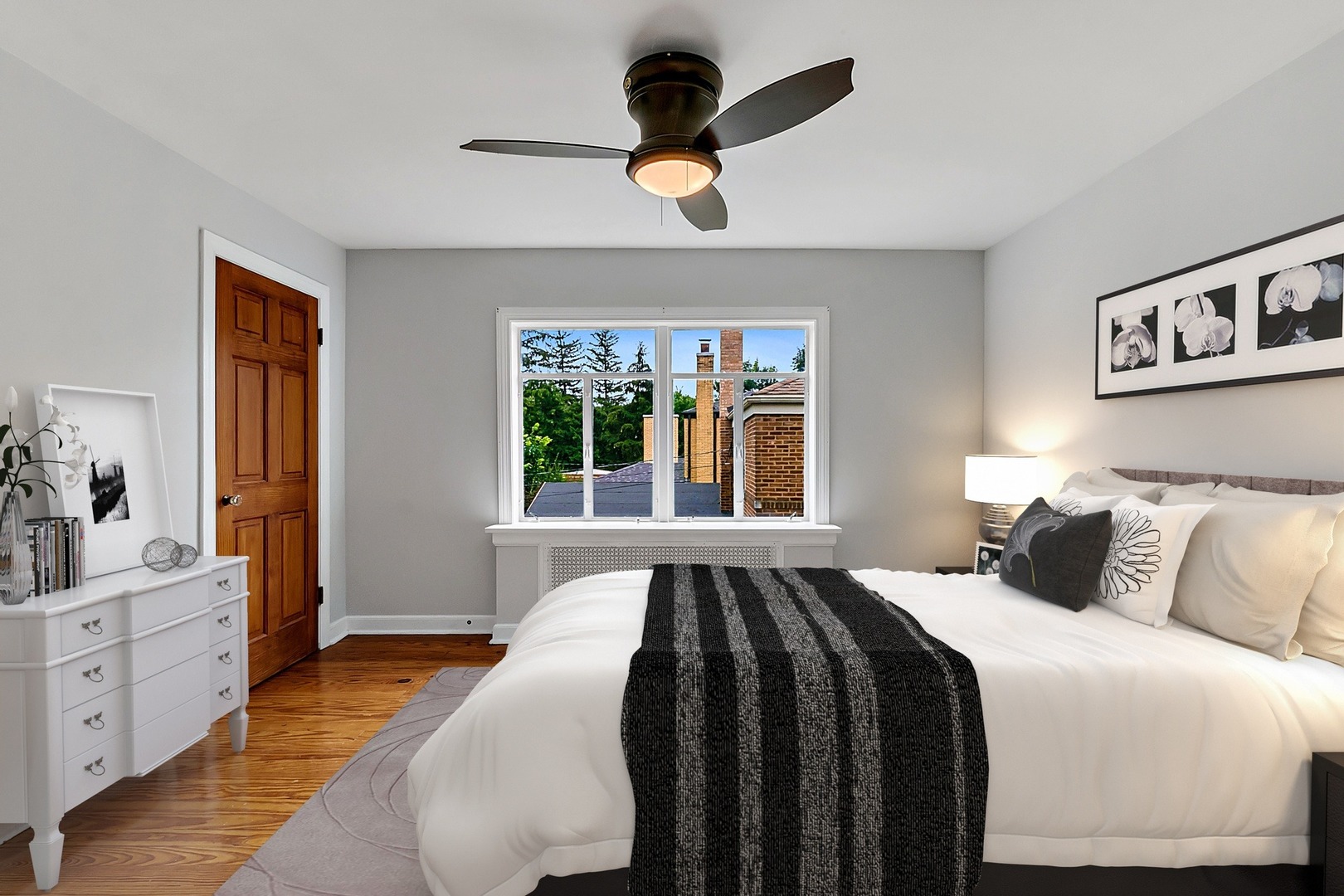 595 East Parkway Road Riverside, IL 60546 - Photo 18 of 35 a bedroom with a large bed and a chandelier