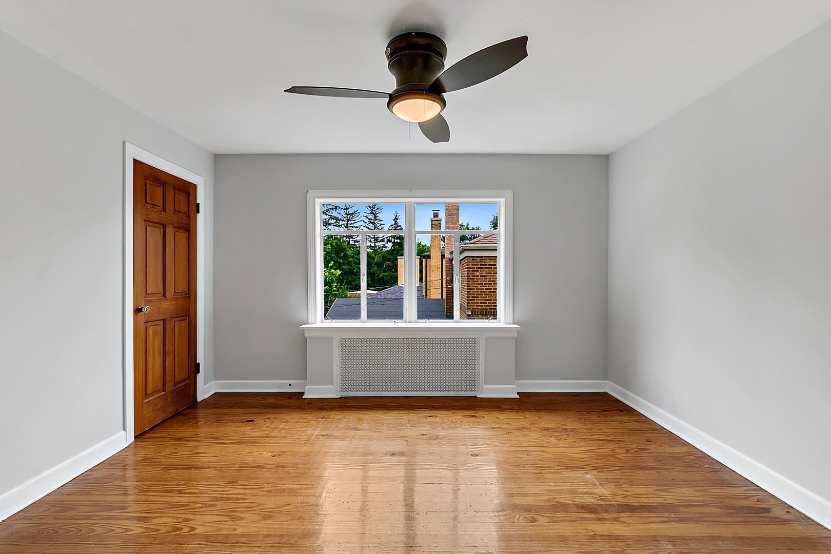 595 East Parkway Road Riverside, IL 60546 - Photo 19 of 35 a view of an empty room with window and chandelier fan