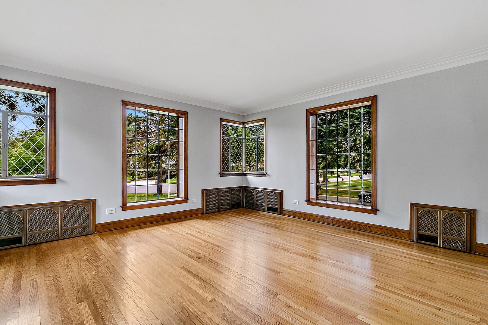 595 East Parkway Road Riverside, IL 60546 - Photo 4 of 35 a view of an empty room with a window and wooden floor