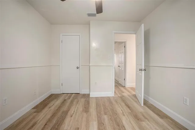 a view of a room with wooden floor