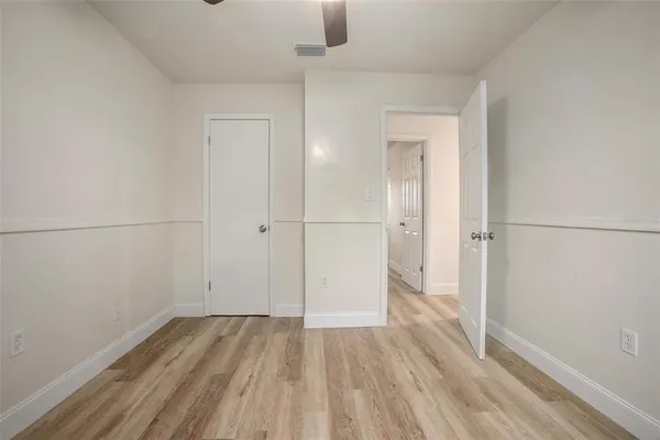 a view of a room with wooden floor