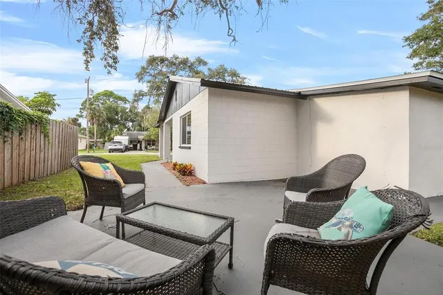 a backyard of a house with table and chairs