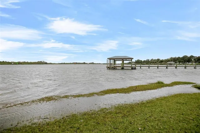 a view of a lake with houses in the back