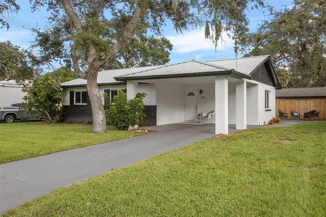 a front view of house with yard and green space