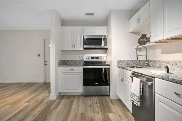 a kitchen with a sink stove and refrigerator
