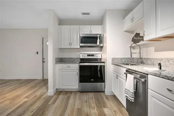 a kitchen with a sink stove and refrigerator