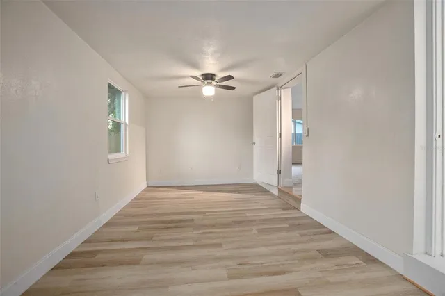 wooden floor in an empty room with a window