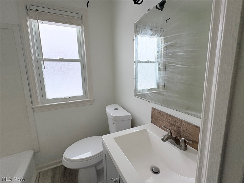 15521 Corkhill Road Maple Heights, OH 44137 - Photo 13 of 33 Bathroom with vanity, healthy amount of natural light, and a tub