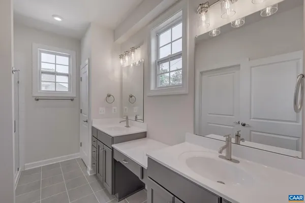 a bathroom with a sink double vanity and a mirror