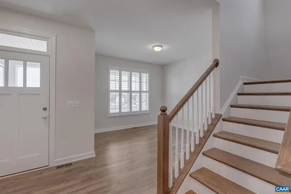 a view of an entryway with wooden floor