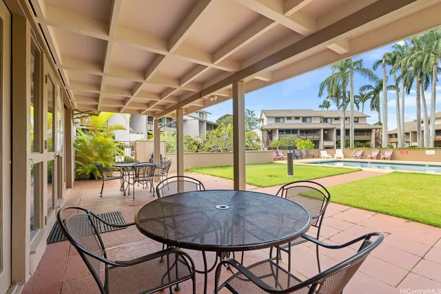 a swimming pool with outdoor seating and yard