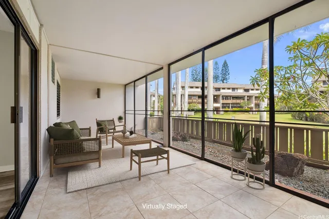 a living room with furniture and a floor to ceiling window
