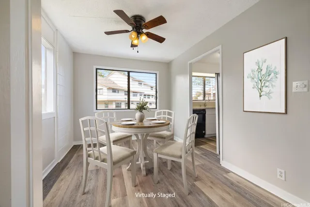 a view of a dining room with furniture window and wooden floor