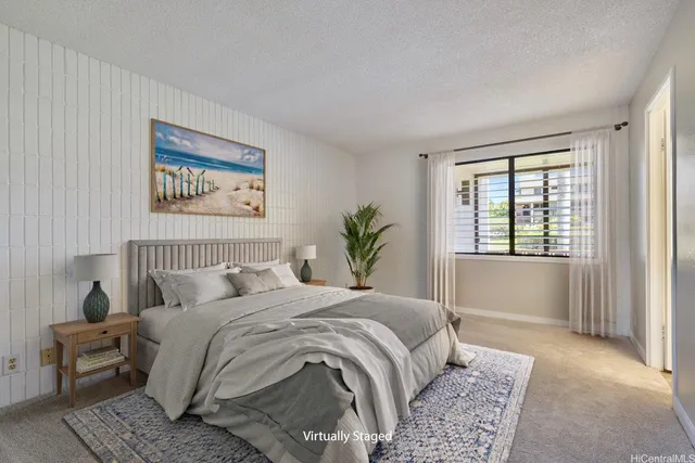 a bedroom with a large bed and a window