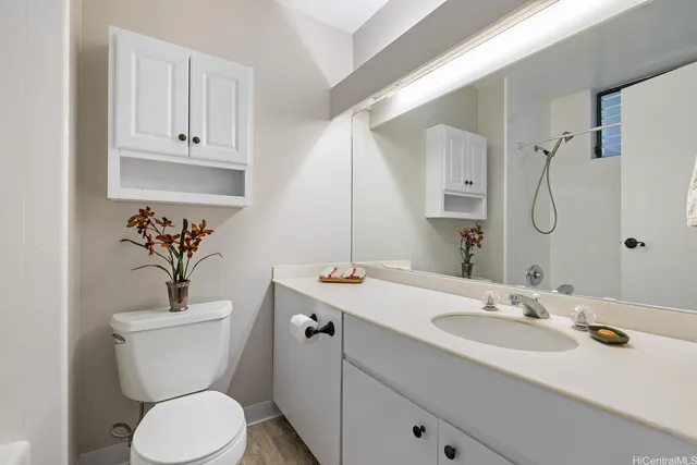 a bathroom with a toilet sink and mirror