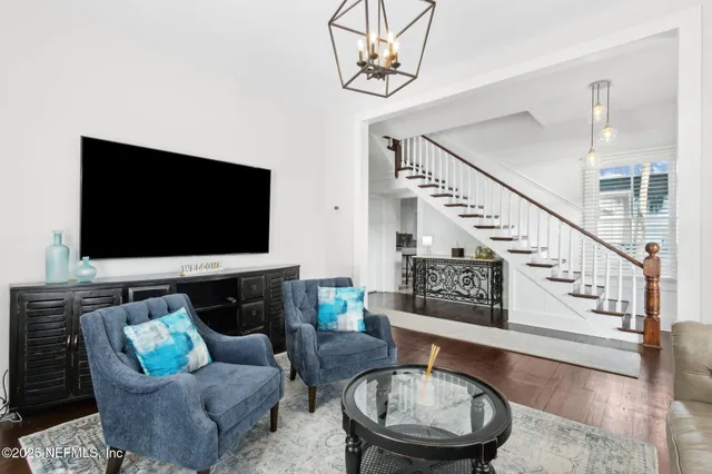 a view of a house with a yard and palm trees