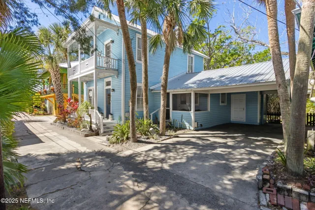 a view of a dining room with furniture a chandelier and wooden floor