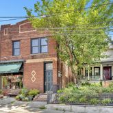 a front view of a building with a garden
