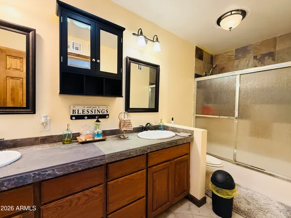 a bathroom with a double vanity sink and a mirror