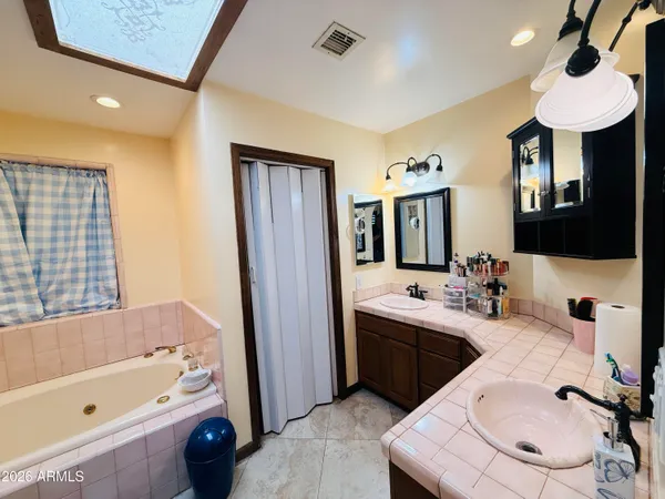 a kitchen with a sink a refrigerator and cabinets